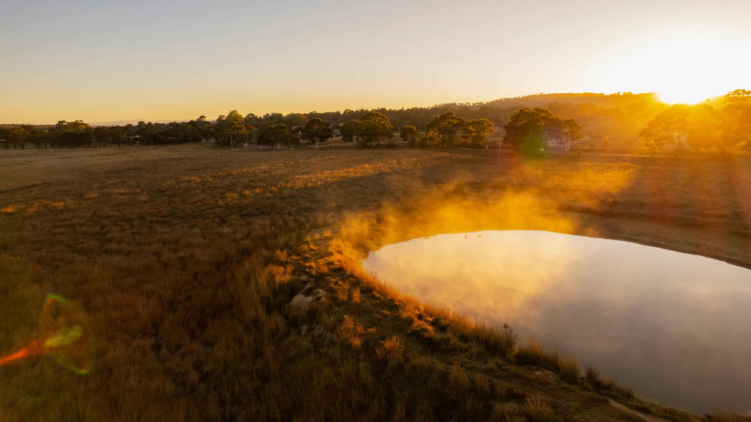View of the water hole at sunset in Sutton